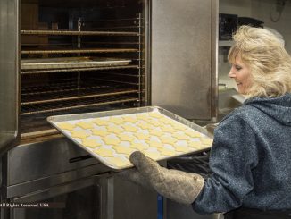 Diane Udell at the oven, preparing to cook customer Christmas meals for Tippens Specialty Wine & Foods in Lodi Township Michigan