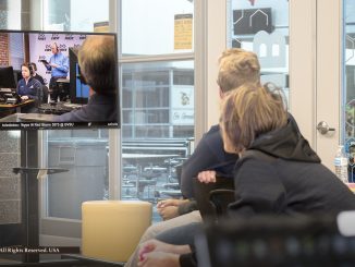 FIRST Robotics Competition team "Saline Singularity" watches 2019 game on televisions at local high school reveal via satellite